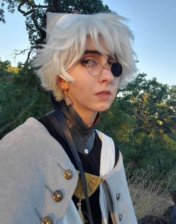 glasses are memory wire, foam clay, and repurposed plastic packaging. collar is strips of leather sewn together at the back. it braids together in the front, held shut with temporary adhesive and a pin.