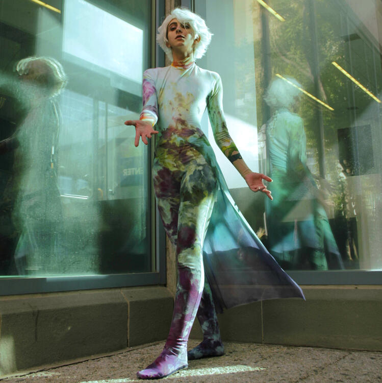 the trail is hand painted with a combination of Dye‐Na-Flow for the majority and procion dye mixed with acrylic paint and textile medium at the hips to match the textures of the dye on the bodysuit. (photo by Gabriella Stefany)